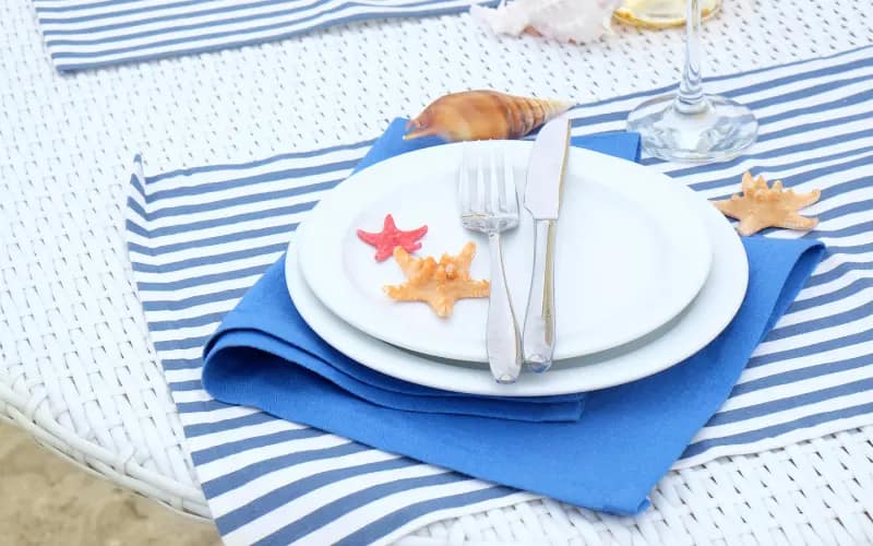 Elegant table setting with shells, illustrating a hobby for women in their 20s interested in event planning.