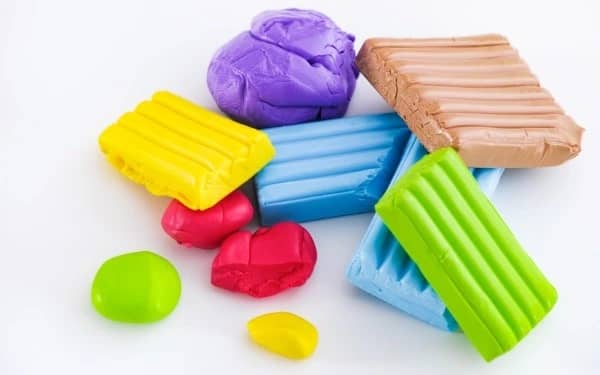 Bright colorful modeling clay pieces symbolizing easy indoor hobbies for women in their 20s to make money and explore creativity at home.